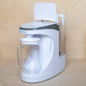 AquaTru Carafe Reverse Osmosis water purifier with lid open for refilling rear tank.