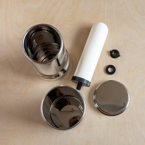 1L Adventure British Berkefeld stainless steel drinking water gravity filter with parts disassembled - top view.