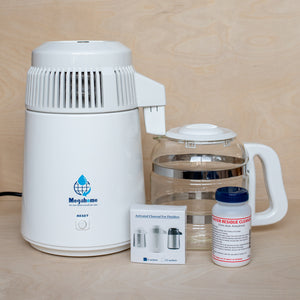 White Megahome Water Distiller show with Activated Charcoal packets and Residue Cleaner (included)