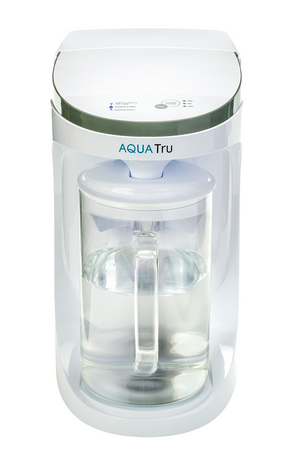 AquaTru Carafe water purifier front view showing indicator light during operation.