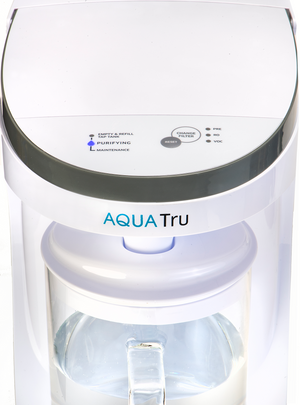 AquaTru Carafe water purifier front close-up view showing indicator light during operation.