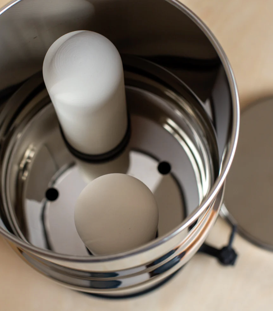 Top down view of ceramic filters installed inside upper chamber of stainless steel gravity filter drinking water system.