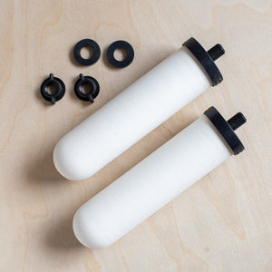 Two British Berkefeld Ultra Sterasyl ceramic filters shown with washers and wing nuts.