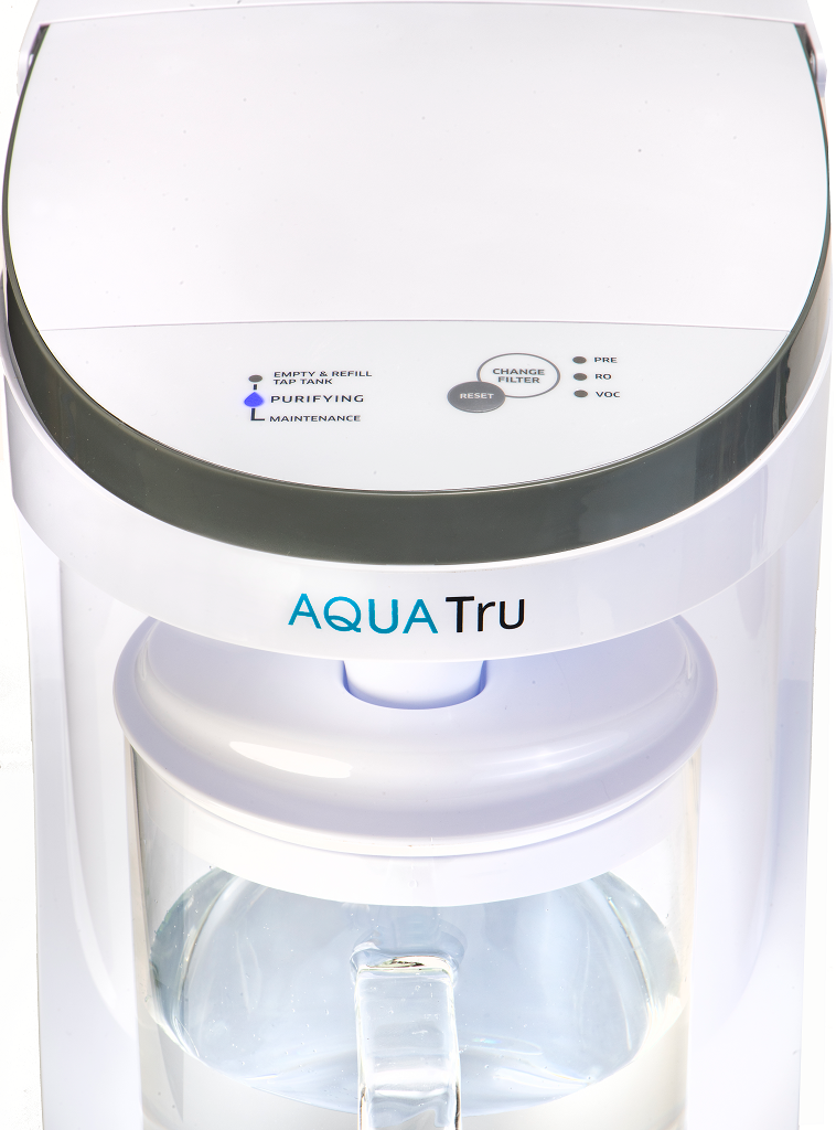 AquaTru Carafe water purifier front close-up view showing indicator light during operation.