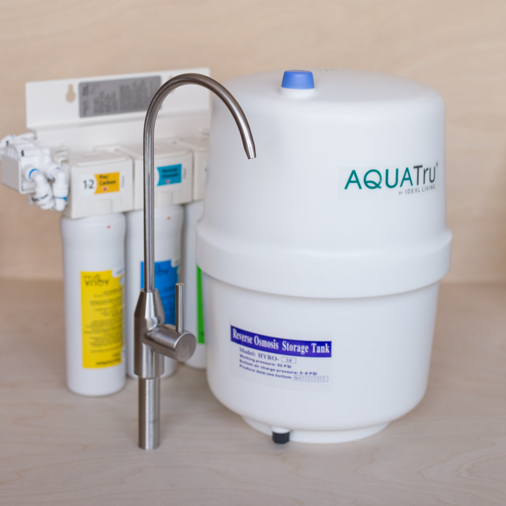 AquaTru Undersink Water Purifier components showing filter manifold storage tank and included faucet.