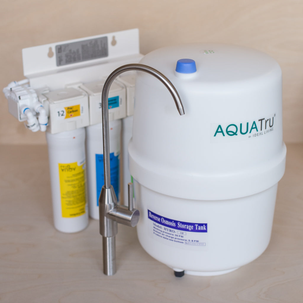Aqua Tru Under sink Water Purifier components showing filter manifold storage tank and included faucet.